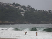 Tourists swim in Acapulco, Mexico, Tuesday, Oct. 24, 2023. Hurricane Otis has strengthened from tropical storm to a major hurricane in a matter of hours as it approaches Mexico's southern Pacific coast where it was forecast to make landfall near the resort of Acapulco early Wednesday.