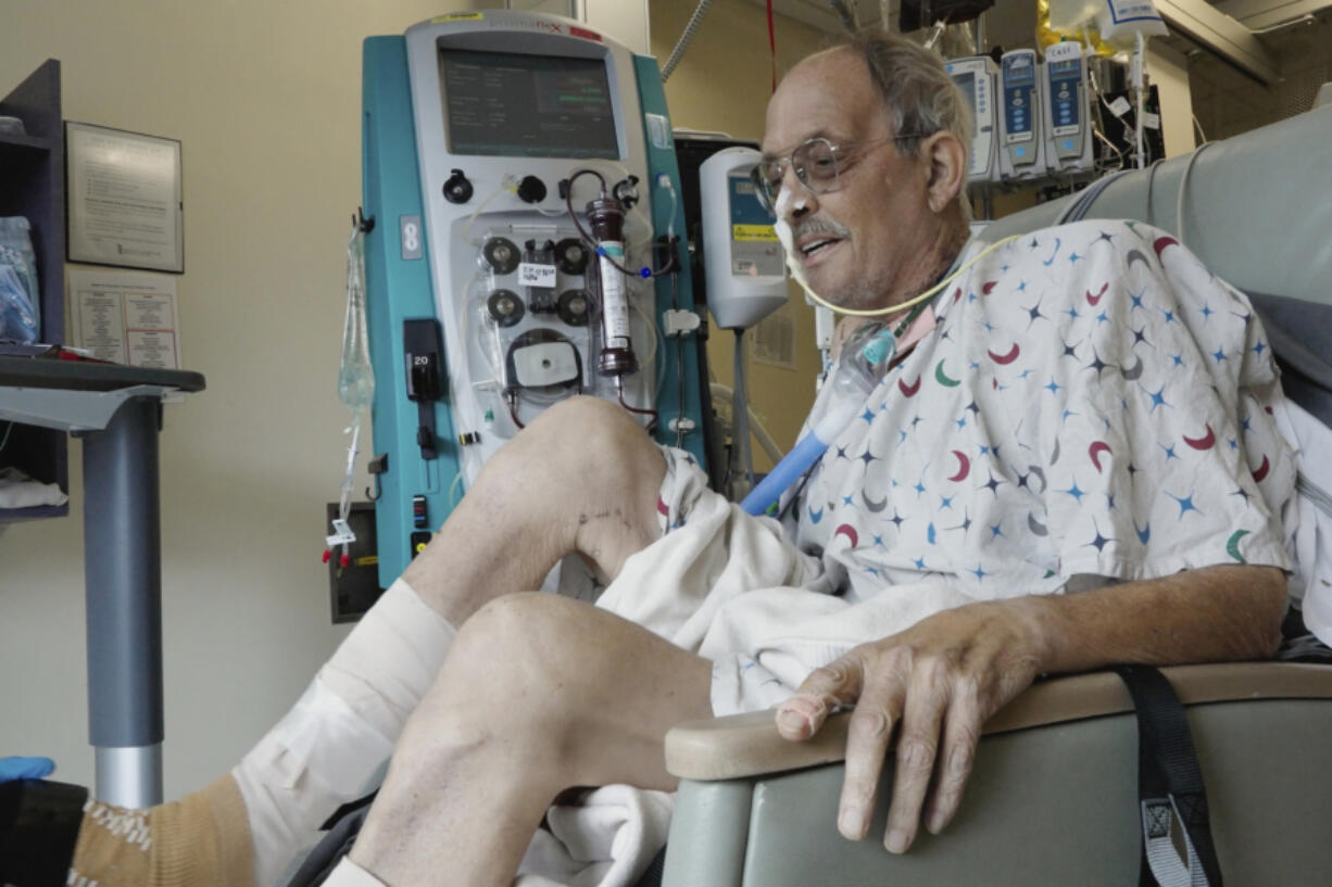 In this image from video provided by the University of Maryland School of Medicine, Lawrence Faucette, a pig heart transplant patient, works with a physical therapist at the school's hospital in Baltimore, Md., on Wednesday, Oct. 18, 2023.