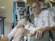 In this image from video provided by the University of Maryland School of Medicine, Lawrence Faucette, a pig heart transplant patient, works with a physical therapist at the school's hospital in Baltimore, Md., on Wednesday, Oct. 18, 2023.