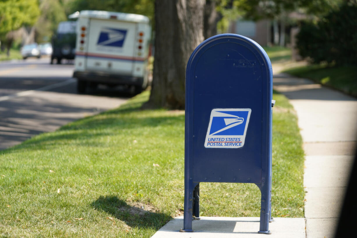 FILE - A United States Postal Service mailbox stands along Bonnie Brae Boulevard Monday, Aug. 17, 2020, in southeast Denver. The U.S. Postal Service says law enforcement officials have charged more than 600 people with postal crimes since launching a crackdown in May. The so-called "Operation Safe Delivery" follows a surge in robberies.