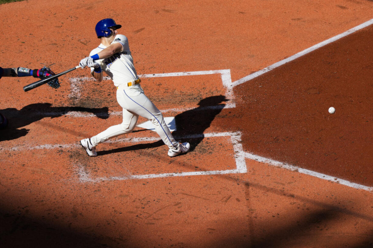 Seattle Mariners' Dominic Canzone follows through on an RBI groundout against the Texas Rangers during the fourth inning of a baseball game Sunday, Oct. 1, 2023, in Seattle.