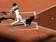 Seattle Mariners' Dominic Canzone follows through on an RBI groundout against the Texas Rangers during the fourth inning of a baseball game Sunday, Oct. 1, 2023, in Seattle.