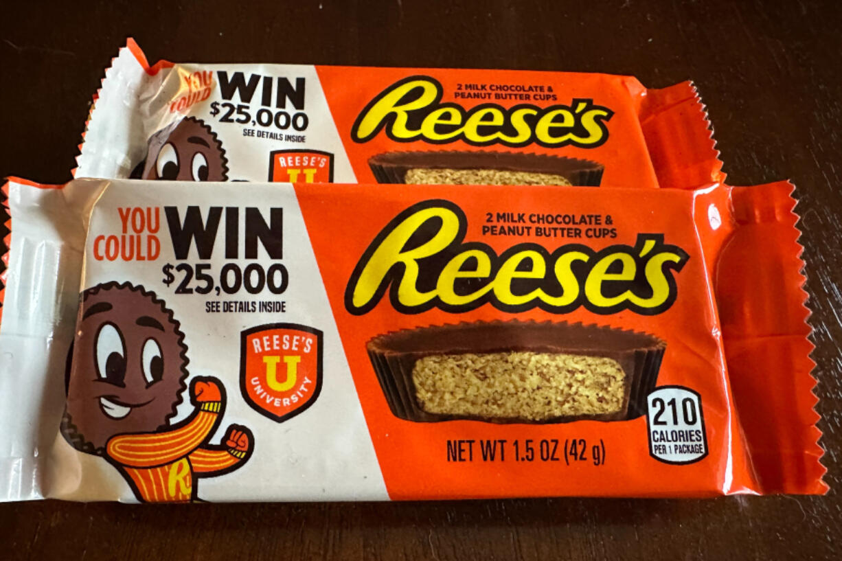 Two packages of Reese's candy featuring a sweepstakes ad are shown in Ann Arbor, MI., on Friday, Oct. 13, 2023. Reese's may be violating state and federal laws with the sweepstakes offer.