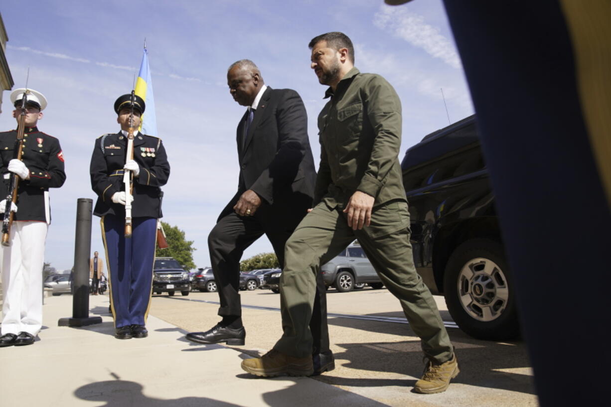 FILE - Secretary of Defense Lloyd Austin greets Ukrainian President Volodymyr Zelenskyy during a welcome ceremony at the Pentagon, Sept. 21, 2023, in Washington. The Pentagon is warning Congress that it is running low on funding to replace weapons the U.S. has sent to Ukraine and has already been forced to slow down restocking some troops. The warning from the Pentagon comptroller came in a letter sent to congressional leaders and was obtained by The Associated Press.