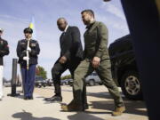 FILE - Secretary of Defense Lloyd Austin greets Ukrainian President Volodymyr Zelenskyy during a welcome ceremony at the Pentagon, Sept. 21, 2023, in Washington. The Pentagon is warning Congress that it is running low on funding to replace weapons the U.S. has sent to Ukraine and has already been forced to slow down restocking some troops. The warning from the Pentagon comptroller came in a letter sent to congressional leaders and was obtained by The Associated Press.