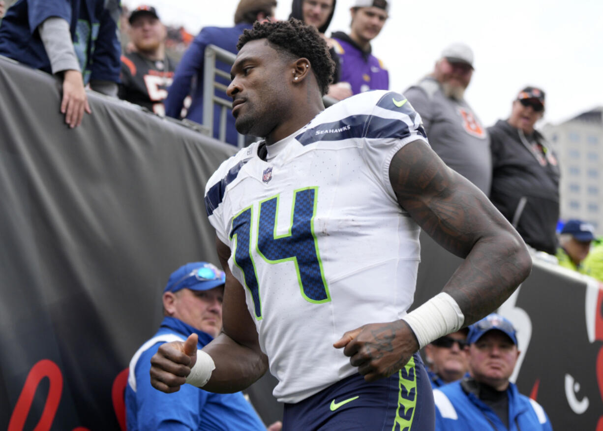 Seattle Seahawks wide receiver DK Metcalf (14) jogs to the tunnel during an NFL football game against the Cincinnati Bengals, Sunday, Oct. 15, 2023, in Cincinnati.