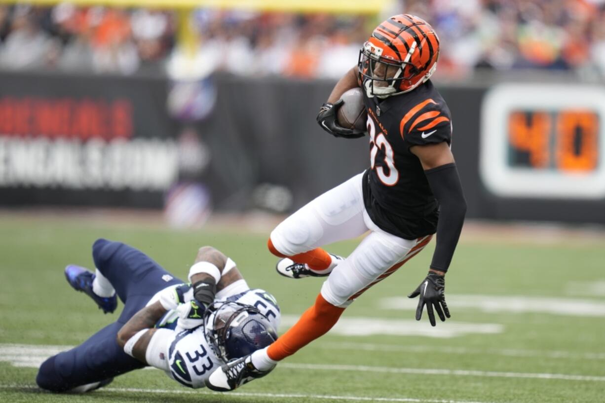 Cincinnati Bengals' Tyler Boyd (83) is tackled by Seattle Seahawks' Jamal Adams during the first half of an NFL football game, Sunday, Oct. 15, 2023, in Cincinnati.