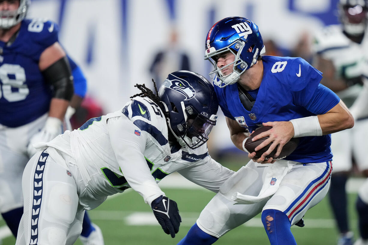 Seattle Seahawks defensive tackle Myles Adams (95) sacks New York Giants quarterback Daniel Jones (8) during the fourth quarter of an NFL football game, Monday, Oct. 2, 2023, in East Rutherford, N.J.