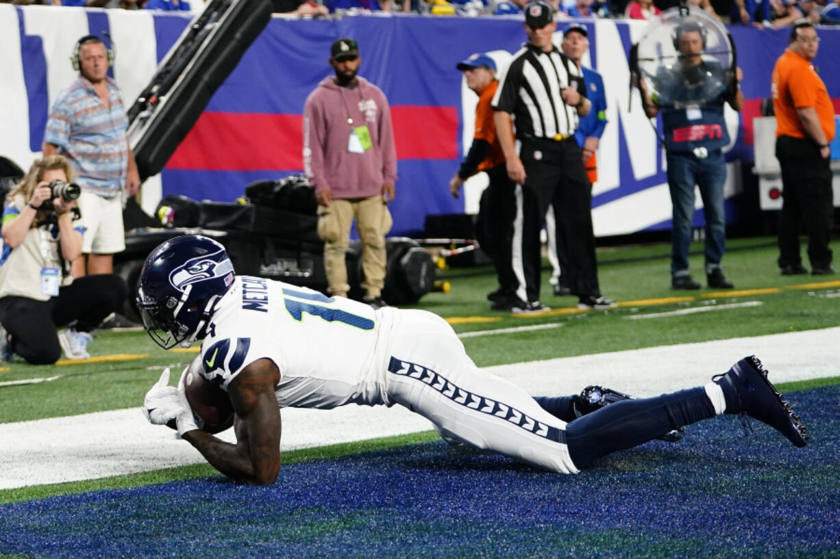 Seattle Seahawks wide receiver DK Metcalf (14) makes a catch in the end zone for a touchdown against the New York Giants during the first half of an NFL football game, Monday, Oct. 2, 2023, in East Rutherford, N.J.