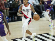 Portland Trail Blazers guard Anfernee Simons brings the ball up against the Phoenix Suns during the second half of an NBA preseason basketball game in Portland, Ore., Thursday, Oct. 12, 2023.