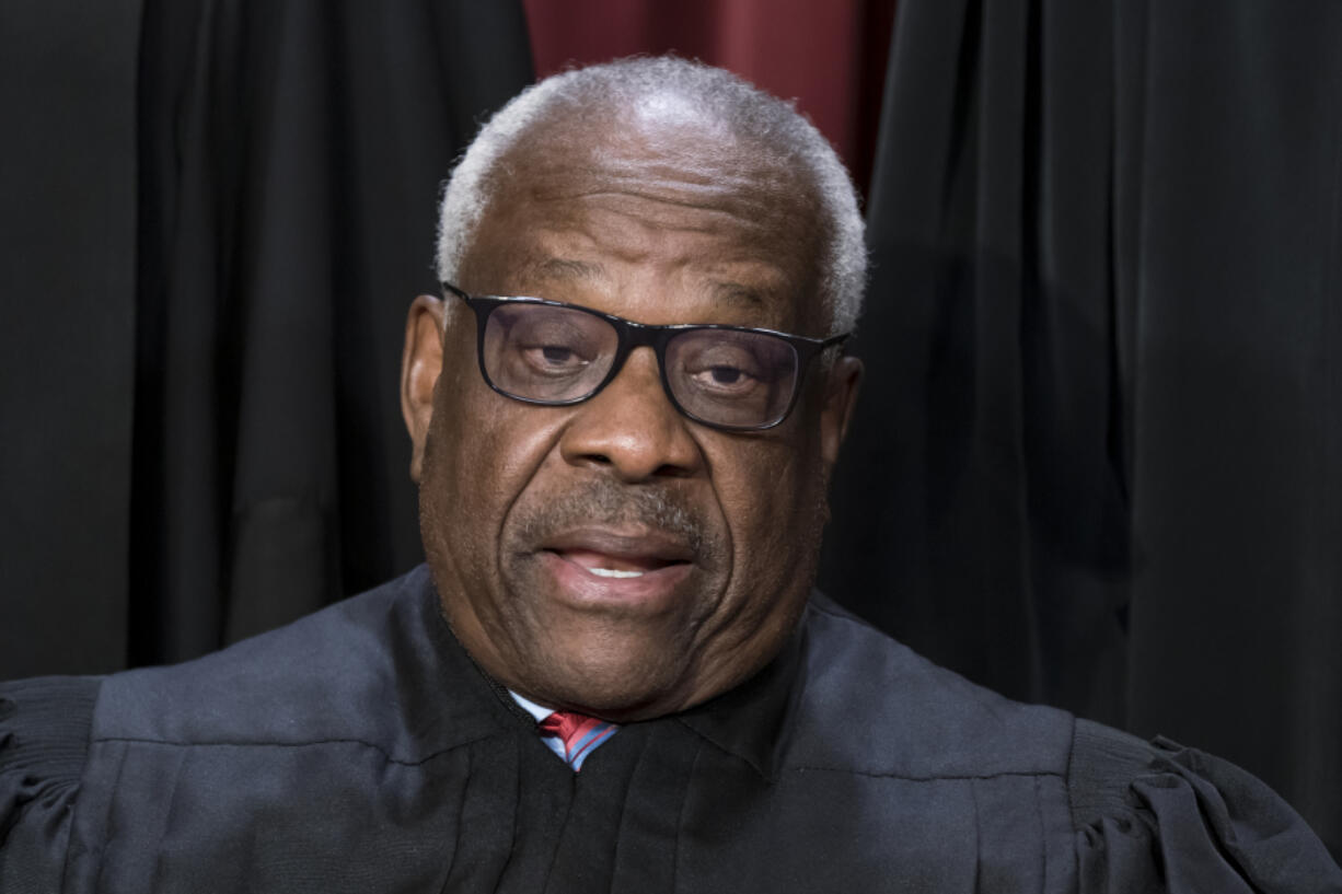 FILE - Associate Justice Clarence Thomas joins other members of the Supreme Court as they pose for a new group portrait, at the Supreme Court building in Washington, Oct. 7, 2022. All or most of a $267,000 loan obtained by Supreme Court Justice Clarence Thomas to buy a high-end motorcoach appears to have been forgiven, raising tax and ethics questions, according to a new report by Senate Democrats. (AP Photo/J.