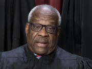 FILE - Associate Justice Clarence Thomas joins other members of the Supreme Court as they pose for a new group portrait, at the Supreme Court building in Washington, Oct. 7, 2022. All or most of a $267,000 loan obtained by Supreme Court Justice Clarence Thomas to buy a high-end motorcoach appears to have been forgiven, raising tax and ethics questions, according to a new report by Senate Democrats. (AP Photo/J.