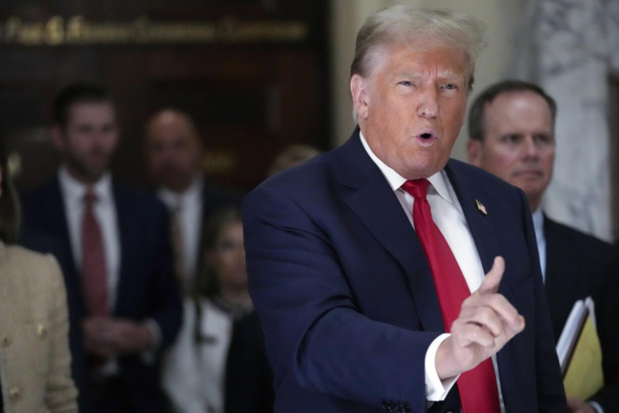 Former President Donald Trump speaks to reporters as he leaves the courtroom during a lunch break in his civil business fraud trial, Oct. 4, 2023, in New York. Trump's lawyers have asked a judge to postpone his Florida classified documents trial until after next year's presidential election. The lawyers say they have not received all the records they need to prepare Trump's defense.