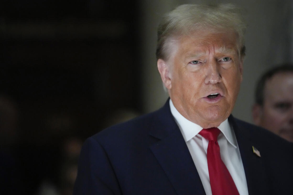 FILE - Former President Donald Trump, speaks to reporters as he leaves the courtroom during a lunch break in his civil business fraud trial, Oct. 4, 2023, in New York. Trump's lawyers have asked a judge to postpone his Florida classified documents trial until after next year's presidential election. The lawyers say they have not received all the records they need to prepare Trump's defense.