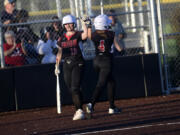 Union's Victoria Ross congratulates Addison Moe (4) after Moe scored in the Titans' 15-11 win over Skyview in the 4A district slowpitch softball championship game at Heritage High School on Thursday, Oct. 19, 2023.