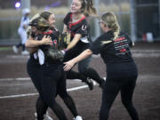 Union's Madison Wirth (from right), Sophia Rickard and Victoria Ross celebrate after the final out in a 15-11 win over Skyview in the 4A district slowpitch softball championship game at Heritage High School on Thursday, Oct. 19, 2023.