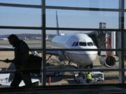 File - A United Airlines plane sits at a gate at Ronald Reagan Washington National Airport in Arlington, Va., Nov. 23, 2022. United Airlines says that it will start boarding passengers in economy class with window seats first starting next week, a move that will speed up boarding times for flights.