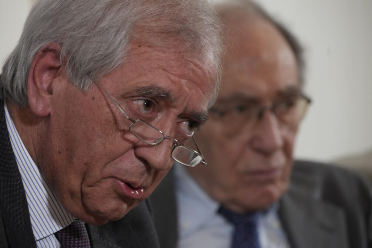 FILE - Former Vatican's first auditor general, Libero Milone, left, speaks flanked by his lawyer Romano Vaccarella during a press conference at the Foreign Press Club in Rome, Thursday, Nov. 17, 2022. Two Vatican trials are coming to a head and posing uncomfortable questions for the Holy See, given they both underscore Pope Francis' absolute power and the legal, financial and reputational problems that can arise when he wields it.