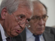 FILE - Former Vatican's first auditor general, Libero Milone, left, speaks flanked by his lawyer Romano Vaccarella during a press conference at the Foreign Press Club in Rome, Thursday, Nov. 17, 2022. Two Vatican trials are coming to a head and posing uncomfortable questions for the Holy See, given they both underscore Pope Francis' absolute power and the legal, financial and reputational problems that can arise when he wields it.