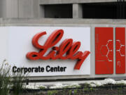 FILE - A sign for Eli Lilly & Co. stands outside their corporate headquarters in Indianapolis on April 26, 2017.  A new study finds that the medicine in the diabetes drug Mounjaro helped people with obesity or who are overweight lose at least a quarter of their body weight.