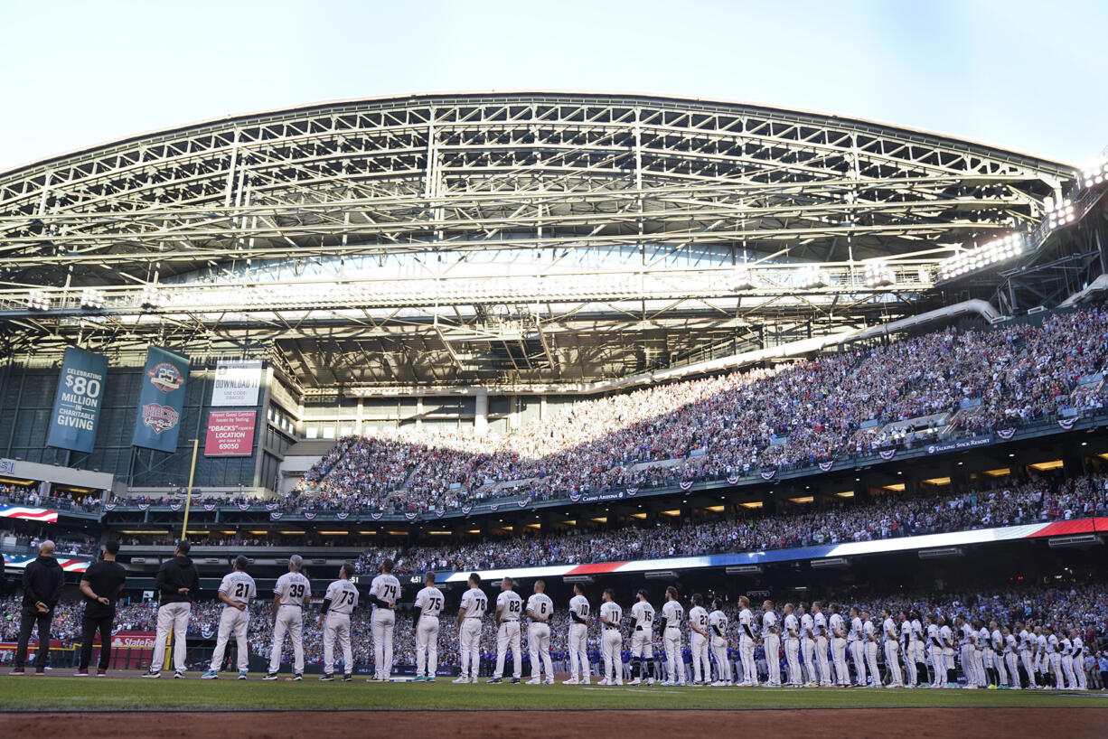 The Arizona Diamondbacks line up for Game 3 of the baseball World Series against the Texas Rangers Monday, Oct. 30, 2023, in Phoenix. (AP Photo/Godofredo A.