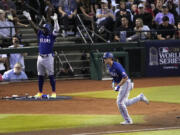 Texas Rangers' Corey Seager, right, watches his two-run home run as Adolis Garcia, left, reacts during the third inning in Game 3 on Monday. (Ross D.