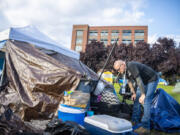 Lonny Klugman, a member of the city of Vancouver's Homeless Assistance and Resources Team, talks to an encampment resident outside Vancouver City Hall. Klugman is a veteran who experienced homelessness and uses his experience to help others.