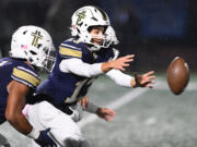 Seton Catholic sophomore Kolten Gesser, center, reaches for the snap Friday, Nov. 3, 2023, during the Cougars’ 51-7 win against Tenino at Seton Catholic High School.