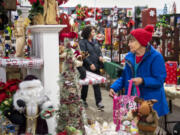 Carol Tuttle of Vancouver looks for Christmas decorations Friday at ReTails Thrift Store. The holiday store will run the entire season, wrapping up around the end of Christmas.
