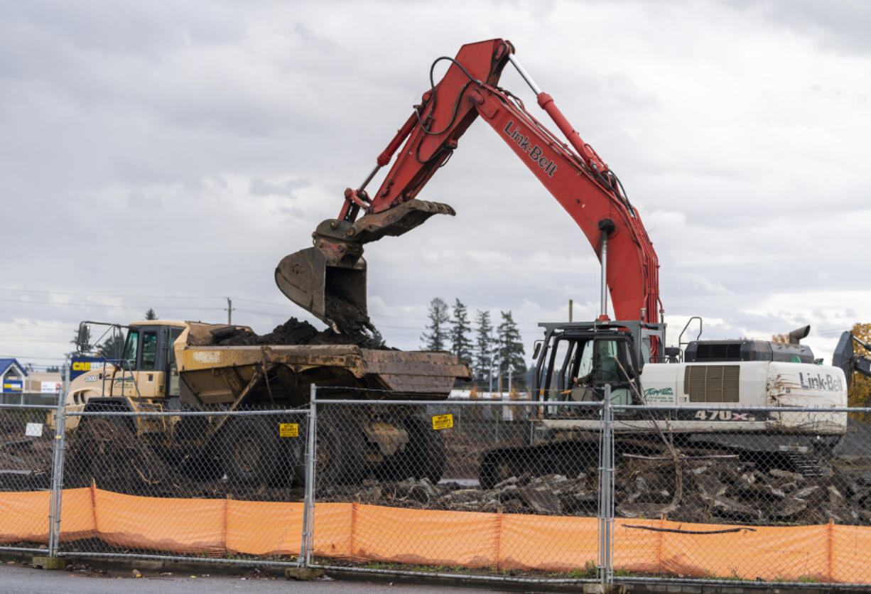 An excavator dumps dirt into the back of a dump truck off Northeast 117th Avenue in Orchards. The mixed-use development is expected to bring hundreds of multifamily units, 11 single-family homes and more than 30,000 square feet of commercial space to the area.