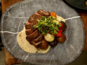 Nostra Tavola serves flat iron steak adorned with smoked peppercorns.