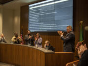 Evergreen School Board members stand and applaud their cohort Victoria Bradford, seated, after she gave a speech Tuesday at Evergreen Public Schools Headquarters. Bradford has served on the school board since 1999, and this was her last meeting after losing her seat to newcomer Gary Wilson in the Nov. 7 election.