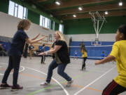 Image Elementary School fifth grader Delilah Folk, 11, left, gets some encouragement from coach Melissa Powers after a successful serve earlier this month. A group of parent volunteers in Evergreen Public Schools has funded and organized a series of seasonal sports leagues for elementary school students this year.