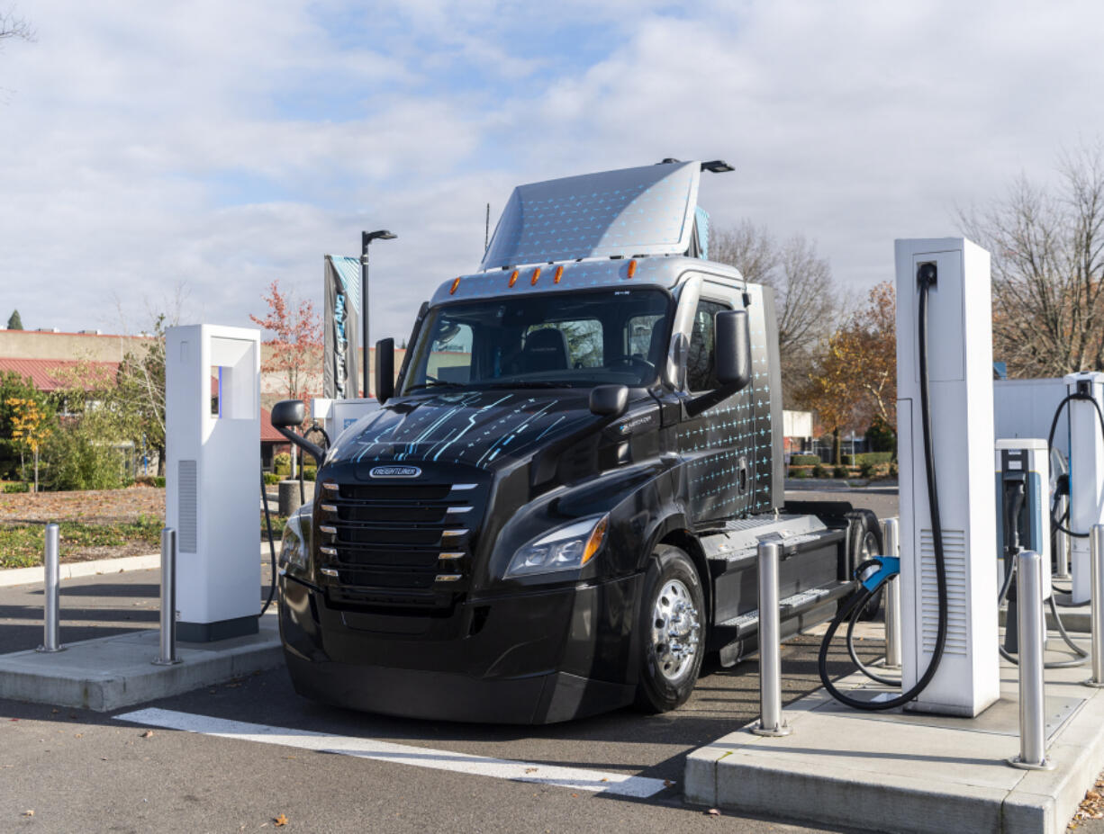 A new eCascadia semitruck sits at a charging station Nov. 16 at Electric Island in Portland. The rig, donated by Daimler Truck, will be used to help collect and sort thousands of pounds of food that Walk &amp; Knock receives every year.