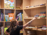 Rachal White organizes the children&rsquo;s section of the bookstore.