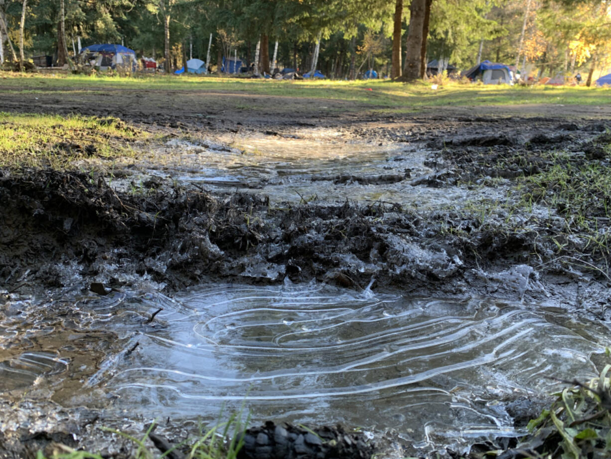 A puddle is frozen over in the Burnt Bridge Creek encampment.