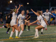 Ridgefield junior midfielder Ellie Wilson raises her hands in the air after tying the game with a 75th-minute goal as Ridgefield junior forward Marlee Buffham and Ridgefield freshman midfielder Savannah Semlick run toward her in the 2A State Girls Soccer Championship on Saturday, Nov. 18, 2023, at Mount Tahoma Stadium in Tacoma.