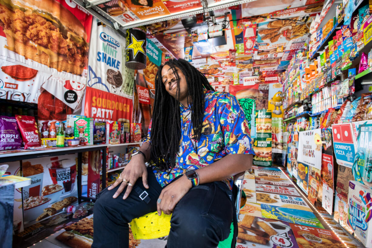 Jaxen McInnis, creator of the Snackin Shack, sits in his transformed garage on Oct. 18 in Everett.