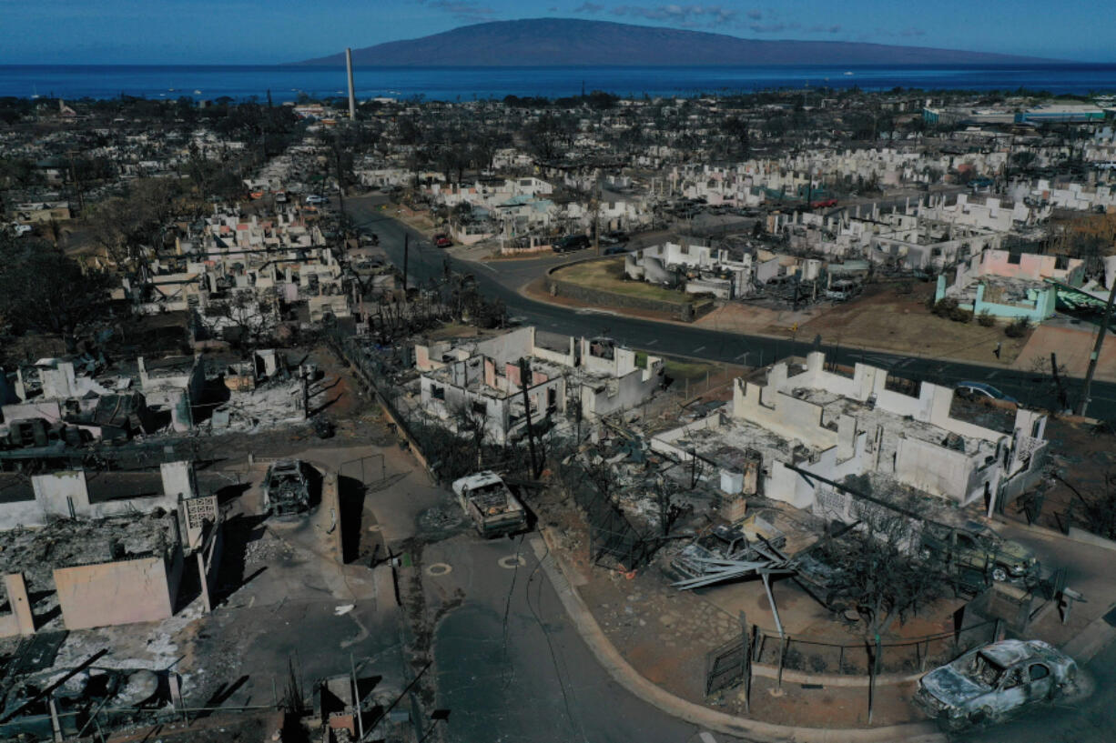 Destroyed homes and vehicles after a wind driven wildfire burned from the hills through neighborhoods to the Pacific Ocean, as seen in the aftermath of the Maui wildfires in Lahaina, Hawaii, on Aug. 17, 2023.  (Patrick T.