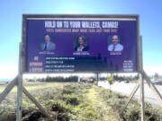 Drivers pass an anonymous campaign sign targeting three Camas officials near the intersection of Southeast 192nd Avenue and Southeast Brady Road on Oct. 28.