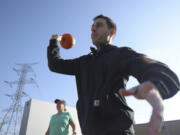 Anthony Uroni of Addison, Ill., throws a pumpkin into a dumpster Nov. 4 during a pumpkin smashing event at School &amp; Community Assistance for Recycling and Composting Education in Addison.