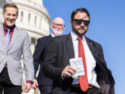 Reps. Dan Crenshaw, R-Texas, right, Rich McCormick, R-Ga., left, and Derrick Van Orden, R-Wis., leave the U.S. Capitol after the last votes of the week on Friday, Nov. 3, 2023.