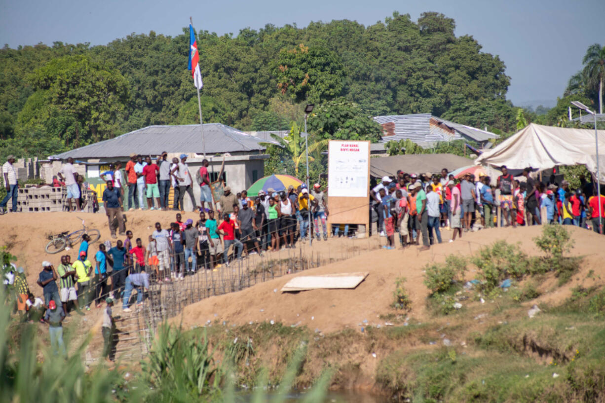 Haitian citizens remain on the banks of the Massacre River, which divides Haiti and Dominican Republic, as seen from Dajabon, Dominican Republic, on Sept. 15, 2023.