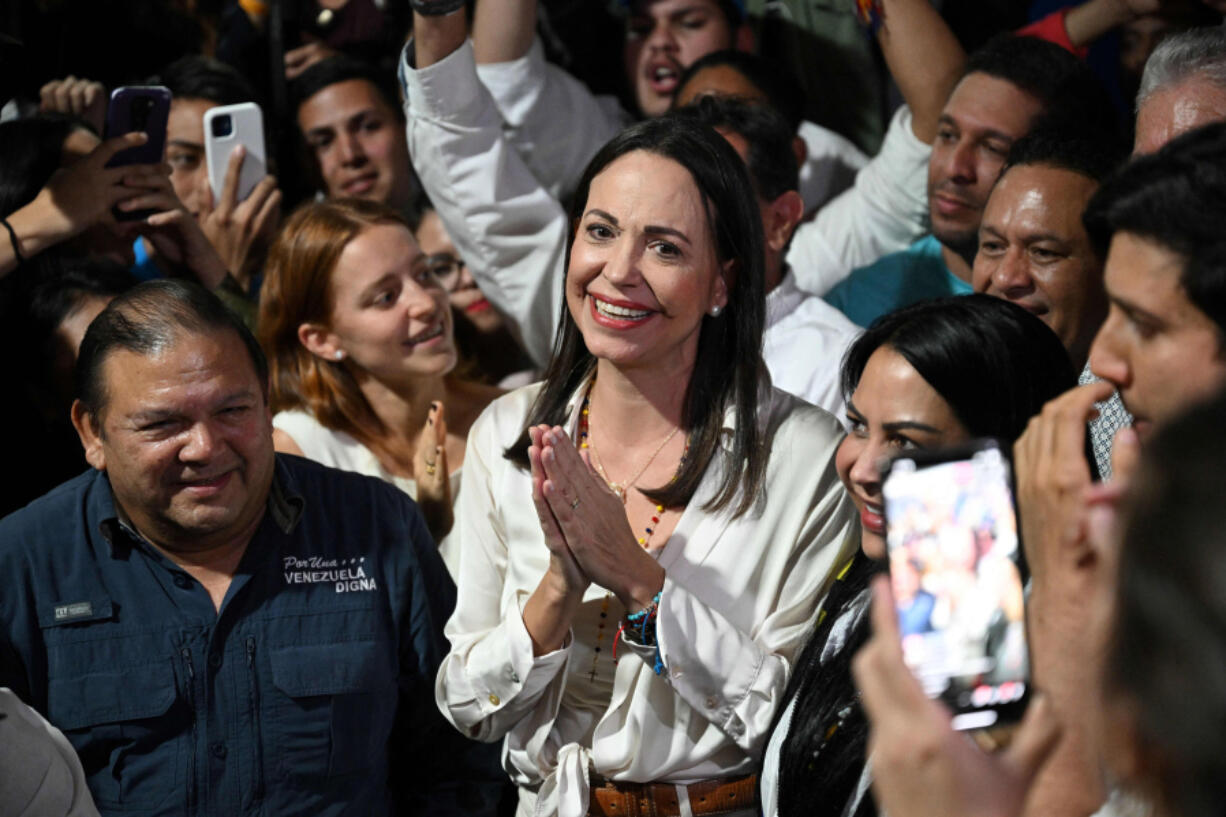 Venezuelan presidential pre-candidate for the opposition Vente Venezuela party, Maria Corina Machado, center, celebrates the results of the opposition&rsquo;s primary elections at her party headquarters in Caracas on Oct. 22, 2023. Venezuela&rsquo;s opposition is voting in primaries that will select a candidate to face President Nicolas Maduro in the elections next year.