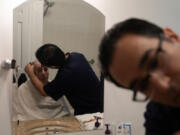 Robert Ingenito shaves his father, Jerry Ingenito, at their home in Mamaroneck, New York, on July 5, 2023.