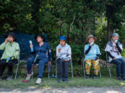 This photo taken on July 27, 2023, shows senior citizens enjoying cool popsicles after playing the croquet-inspired game of &ldquo;gateball&rdquo; at a park in suburban Tokyo. (Richard A.