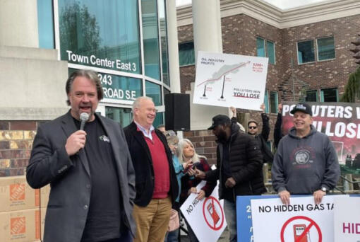 Brian Heywood, from left, founder of Let&rsquo;s Go Washington, stands Tuesday with Washington State Republican Party Chair Jim Walsh in front of boxes of petitions for an initiative to repeal Washington&rsquo;s cap-and invest program.