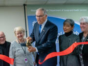 Gov. Jay Inslee cuts the ribbon at a ceremony formally opening Olympic Heritage Health Hospital. Nov. 21, 2023.