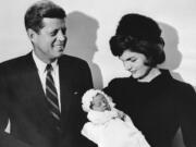 John F. Kennedy and his wife Jacqueline hold their son John during the christening ceremony Dec. 10, 1960, at the chapel of Georgetown University in Washington, D.C.