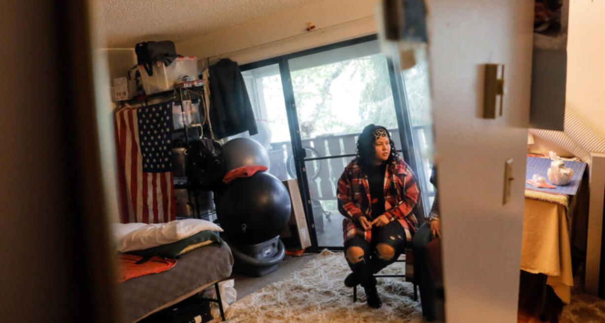 Janell Braxton is reflected in a mirror as she visits with her mother Debra Braxton at Debra&Ccedil;&fnof;&Ugrave;s apartment in Shoreline, Oct. 17, 2023. Braxton spent 12 years in and out of the foster system and then homeless for several years once she aged out. She now works to help other youth transitioning out of the system.